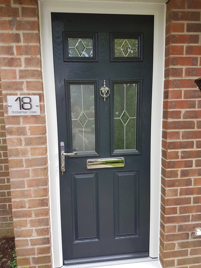 Black composite door with contemporary handle
