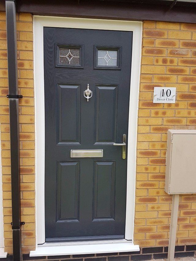 Composite door with integrated letterbox and door knocke