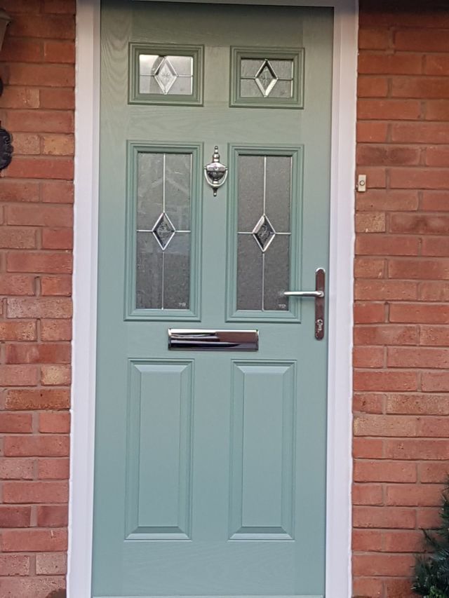 Grey composite door with woodgrain finish